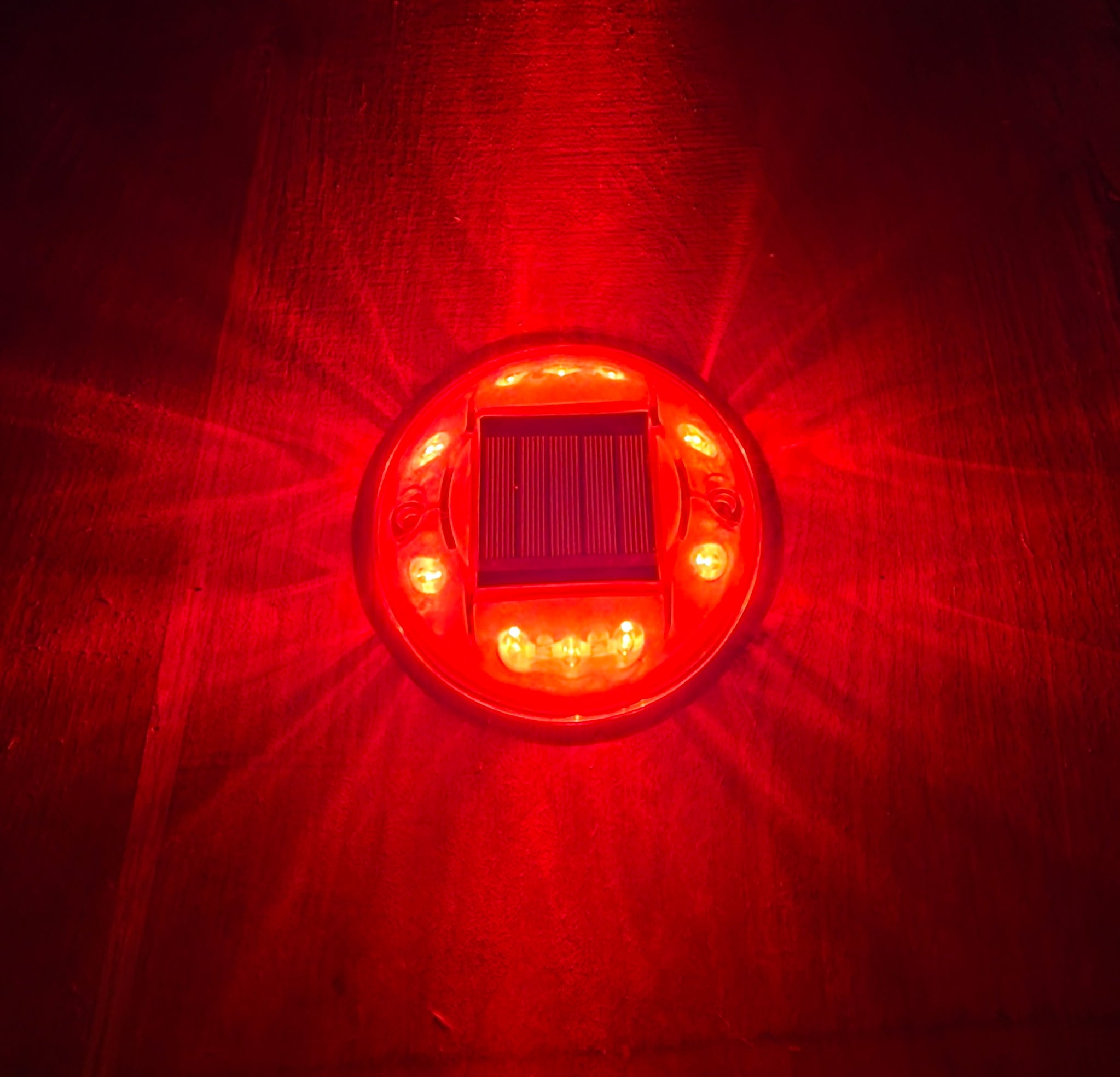 Low‑profile solar dock light marking the edge of a pier at night