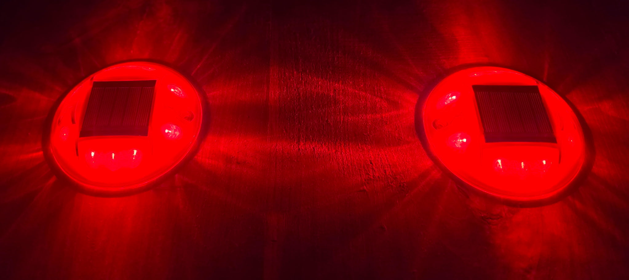 Low‑profile solar dock light marking the edge of a pier at night