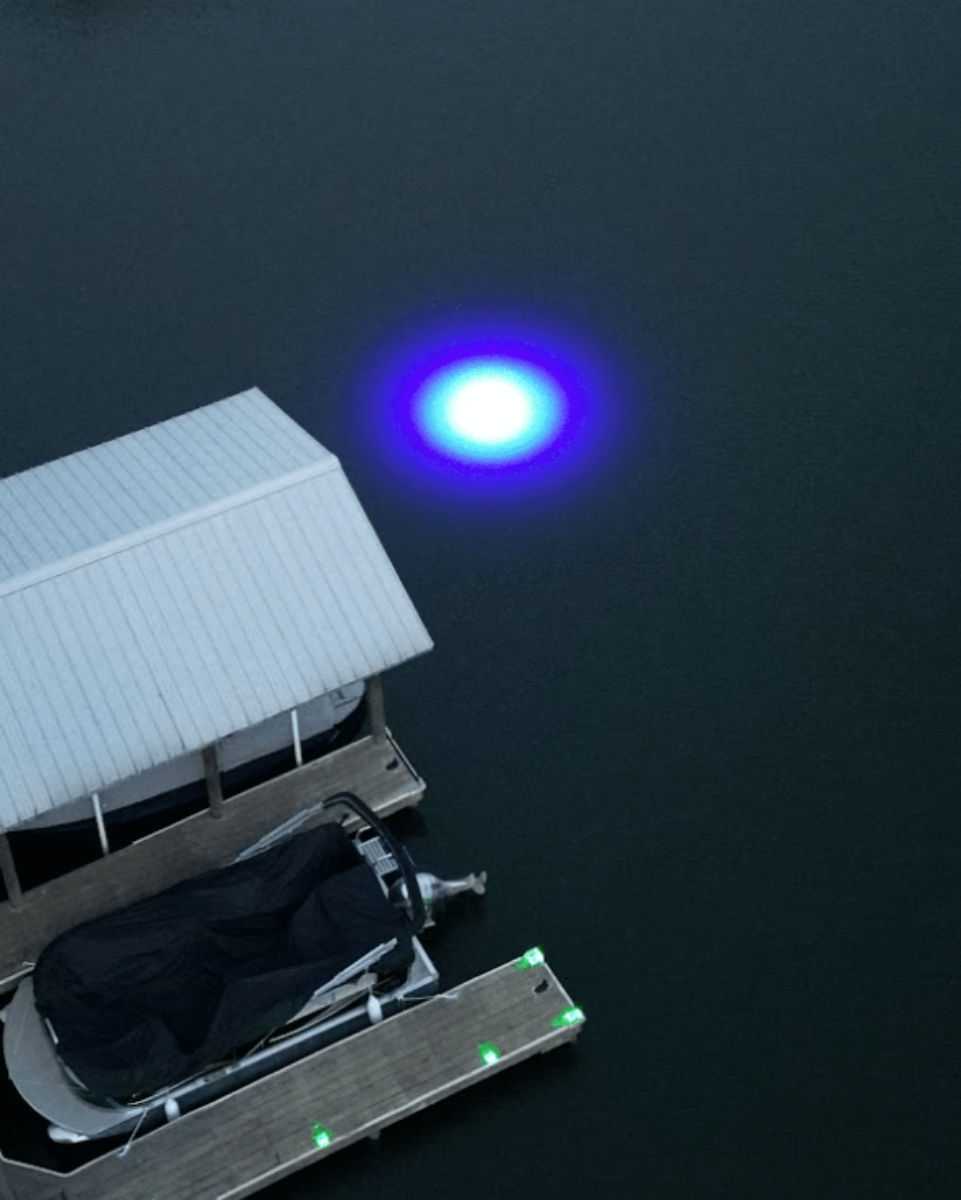Sea floor green underwater dock light creating a glow for night fishing