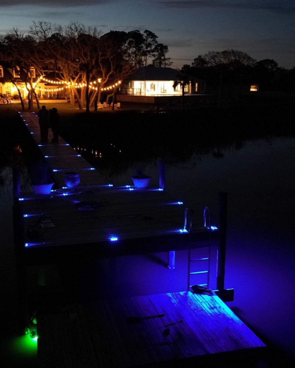 Low‑profile solar dock light marking the edge of a pier at night and an above water dock light
