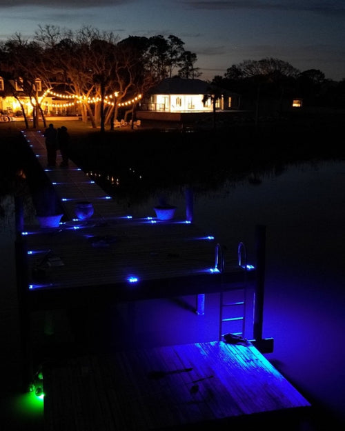 Low‑profile solar dock light marking the edge of a pier at night and an above water dock light