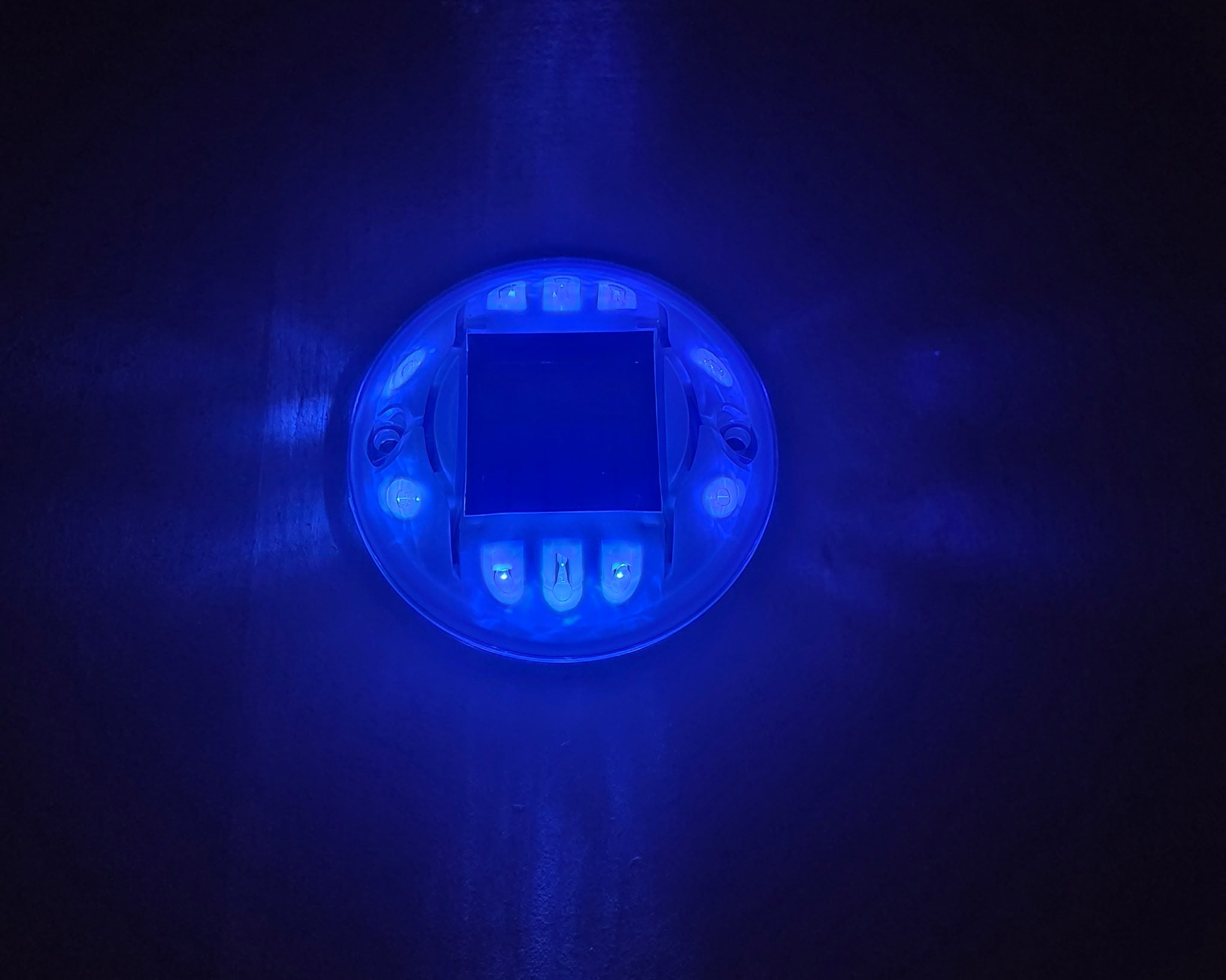 Low‑profile solar dock light marking the edge of a pier at night