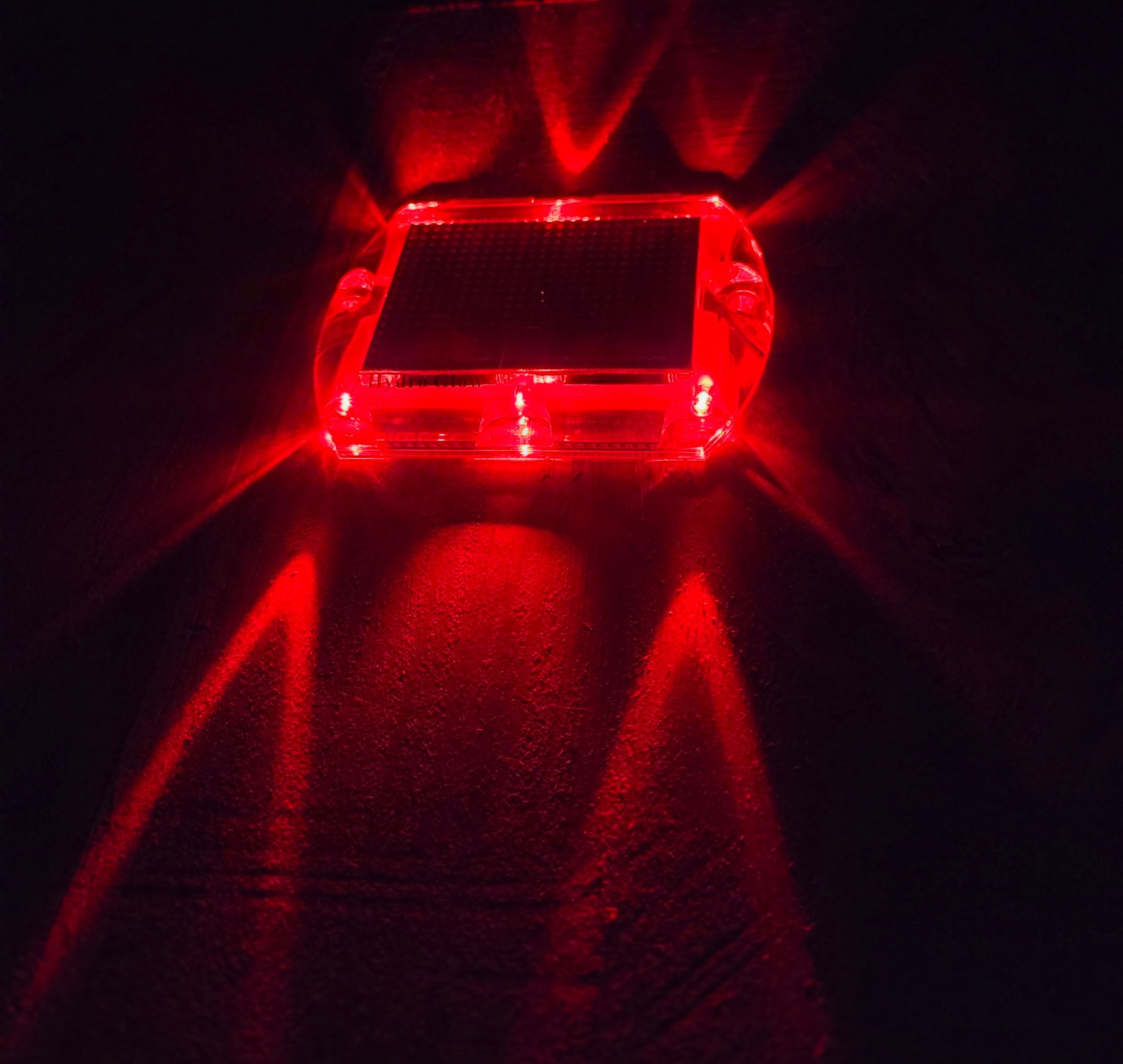 Low‑profile solar dock light marking the edge of a pier at night.