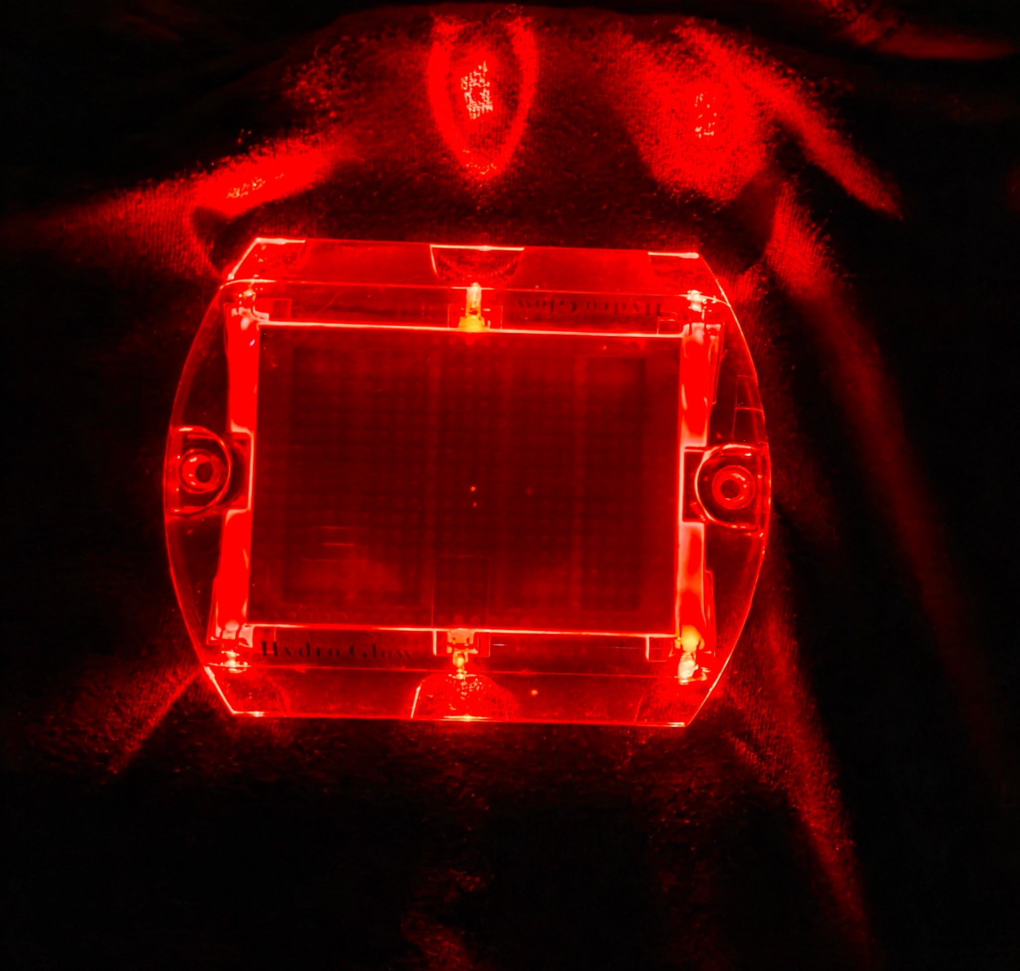 Low‑profile solar dock light marking the edge of a pier at night.
