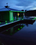 Low‑profile solar dock light marking the edge of a pier at night
