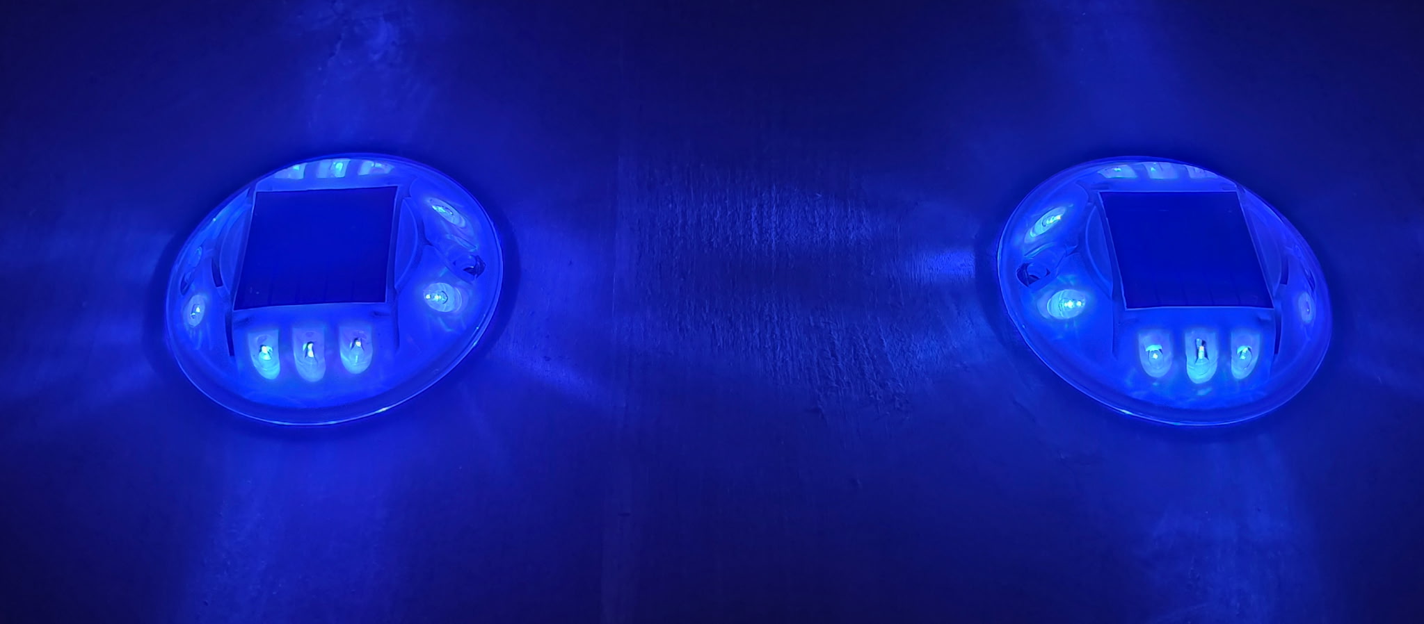 Low‑profile solar dock light marking the edge of a pier at night