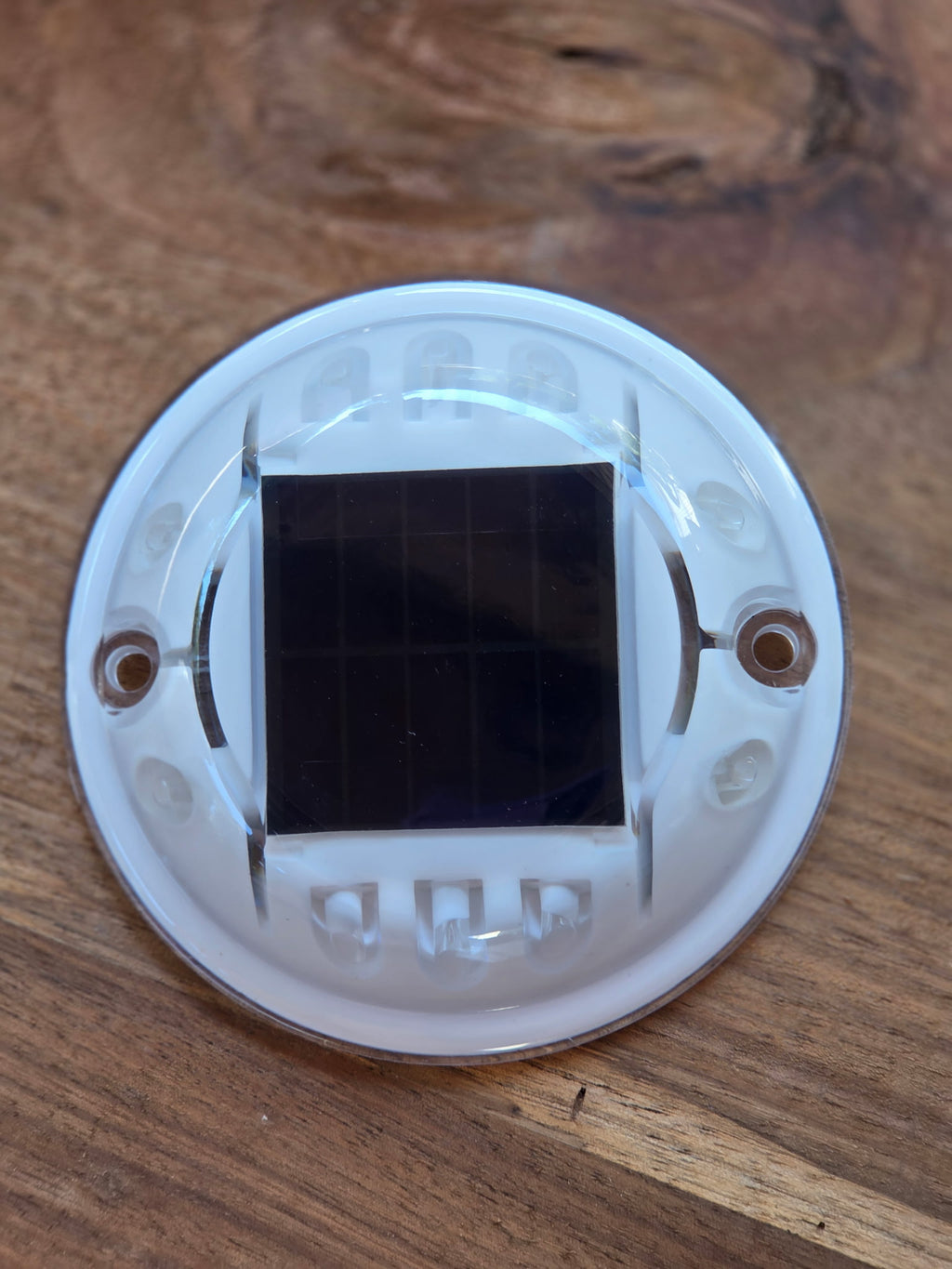 Low‑profile solar dock light marking the edge of a pier at night