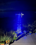 Low‑profile solar dock light marking the edge of a pier at night