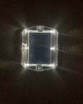 Low‑profile solar dock light marking the edge of a pier at night