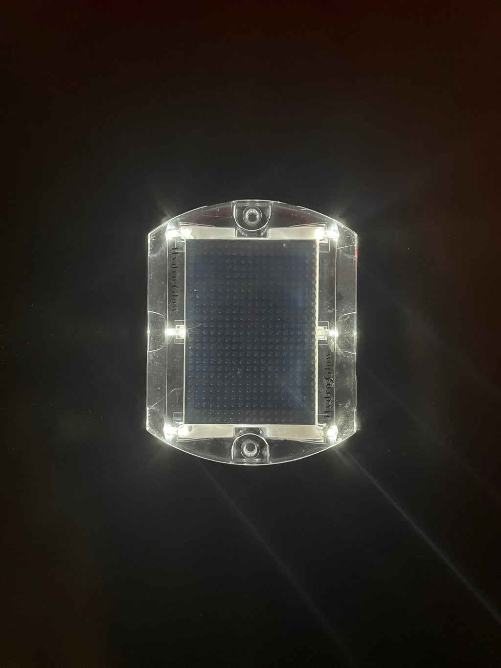 Low‑profile solar dock light marking the edge of a pier at night