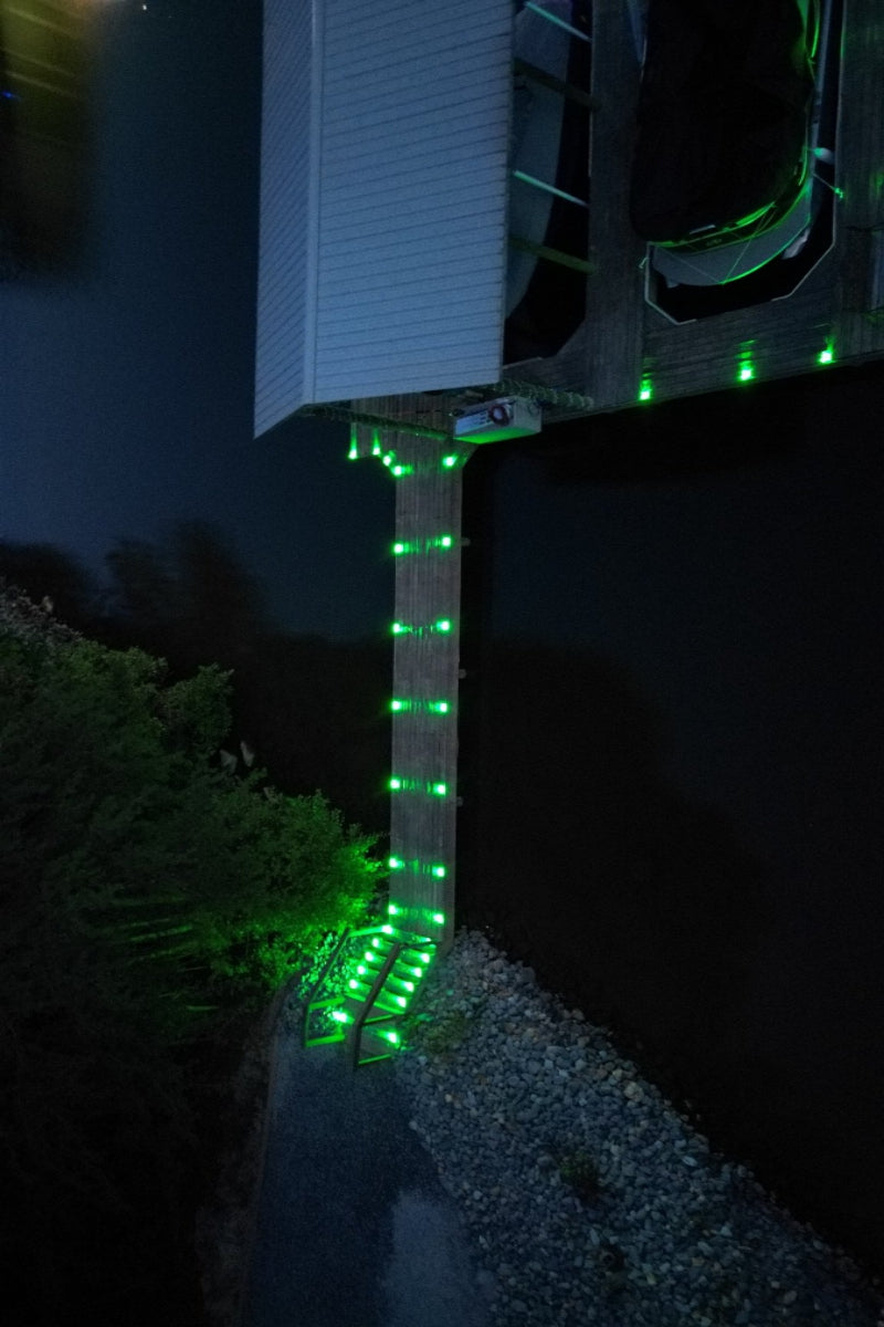 Low‑profile solar dock light marking the edge of a pier at night