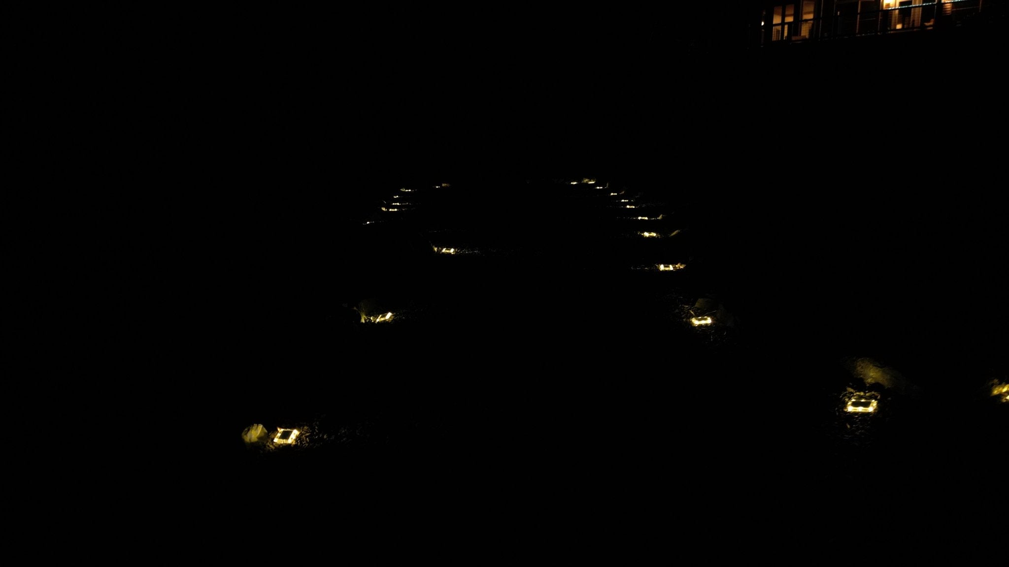 Low‑profile solar dock light marking the edge of a pier at night