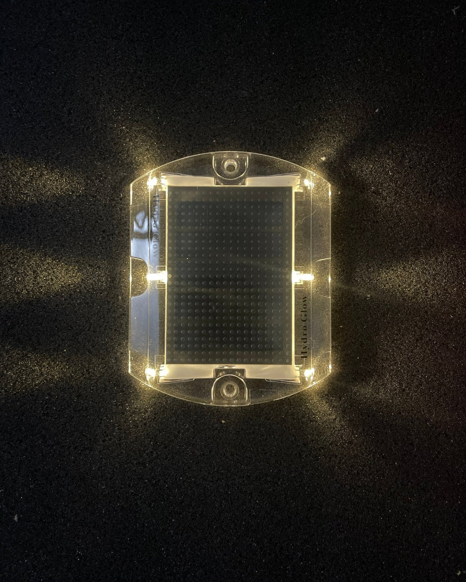 Low‑profile solar dock light marking the edge of a pier at night